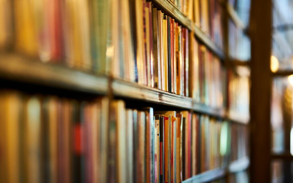 Selective Focus Photography of Brown Wooden Book Shelf